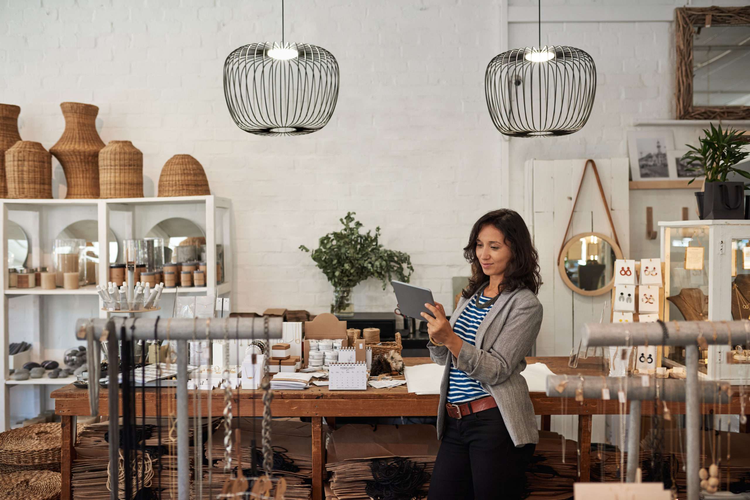 Young Asian woman using a digital tablet in her boutique